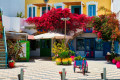 Beautiful square decorated with flowers in the center of Adamas, Milos