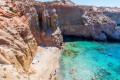 The iconic beach of Tsigrado is a preferred destination for a swim in Milos