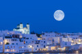 A silver moon lighting up the village of Parikia in Paros