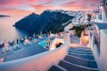 The sky turns pink as the sun sets on Fira in Santorini