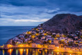 The port of Hydra beautifully illuminated as the night falls on the island