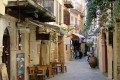 Shops and local taverns on a charming alley in Chania