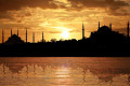 Silhouette of Istanbul at sunset, with the Blue Mosque and Hagia Sophia displayed prominently 