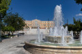 View of the fountain in Syntagma Square with the Greek Parliament on the background