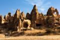 Cappadocia amazing rock formations and horses in Goreme valley, Turkey