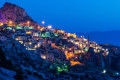 The Uchisar Castle in colorful illuminations as the sun falls in Anatolia