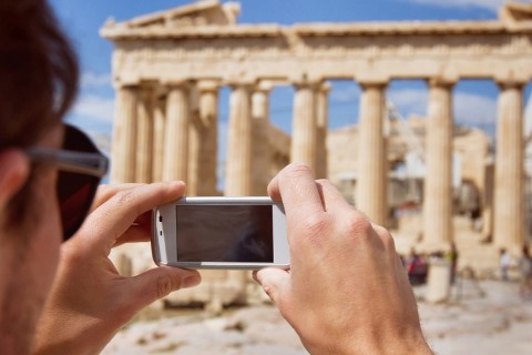 A man taking a photo of Parthenon with his mobile