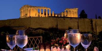 Romantic dinner at the luxurious Divani Palace hotel backdropped by the Parthenon night view, Athens