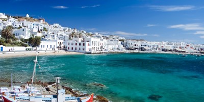 Beautiful bay with turquoise waters encircling the white washed buildings, Mykonos island