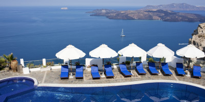 Sunbeds by the pool with amazing sea and caldera view, Santorini island