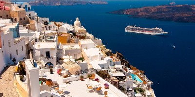 View of candy colored houses perched on the volcanic cliffs of the caldera, Santorini island