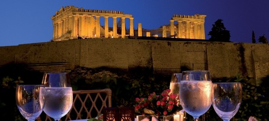 Romantic dinner at the luxurious Divani Palace hotel backdropped by the Parthenon night view, Athens