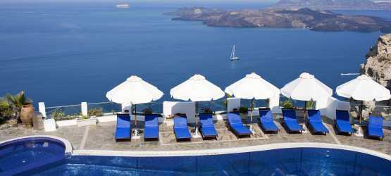 Sunbeds by the pool with amazing sea and caldera view, Santorini island